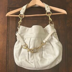 COACH white leather bag with gold hardware.